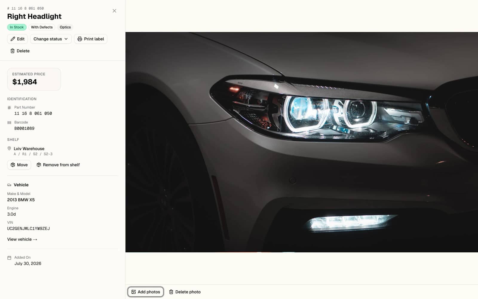 Mottavik part record for a headlight: barcode, shelf address, donor vehicle, photograph